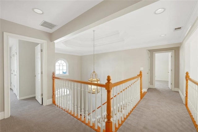 corridor featuring carpet flooring, an upstairs landing, visible vents, and baseboards