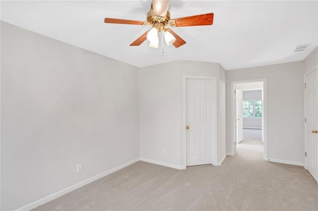 spare room with carpet flooring, visible vents, baseboards, and ceiling fan