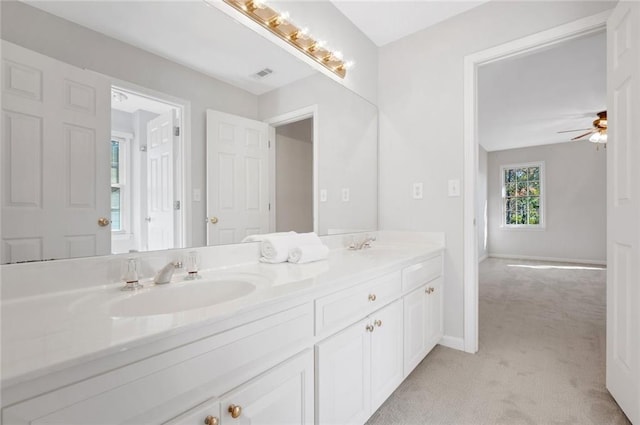 full bath with visible vents, a sink, double vanity, baseboards, and ceiling fan