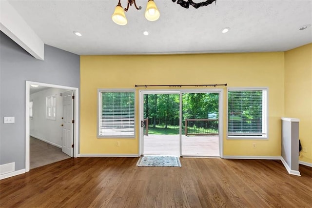 doorway to outside with baseboards, wood finished floors, recessed lighting, and a chandelier