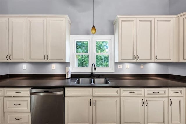 kitchen with stainless steel dishwasher, a sink, dark countertops, and pendant lighting