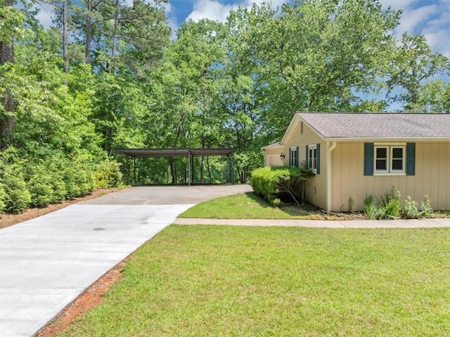 view of side of home with driveway, a lawn, and board and batten siding