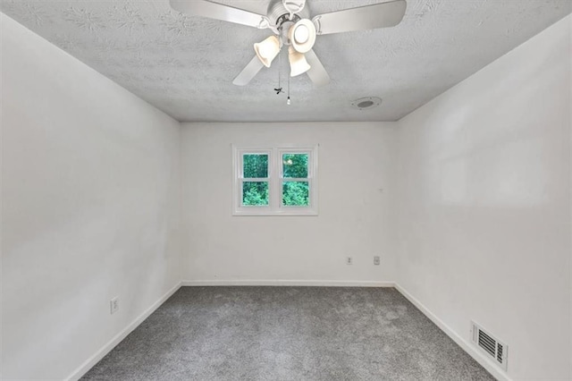 carpeted spare room featuring a textured ceiling, baseboards, and a ceiling fan