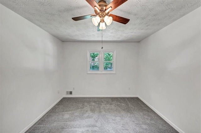 carpeted empty room featuring a textured ceiling, ceiling fan, and baseboards