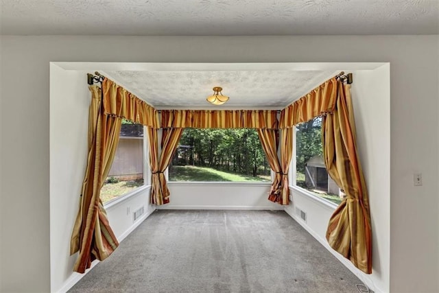 spare room with carpet and baseboards