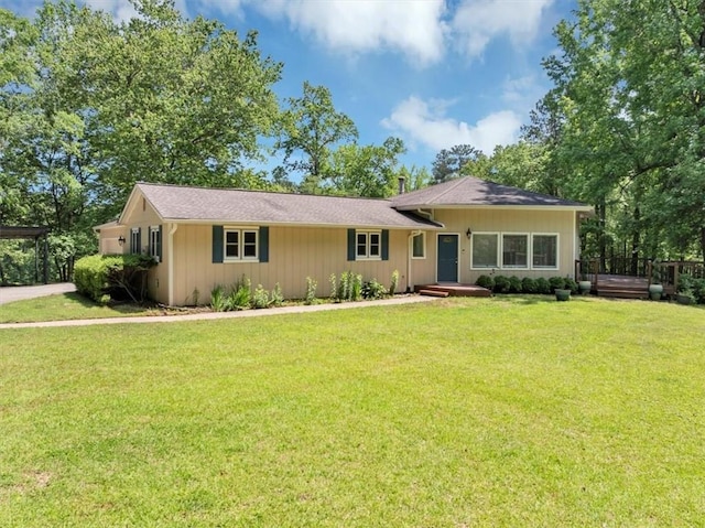 single story home with a front lawn and a carport