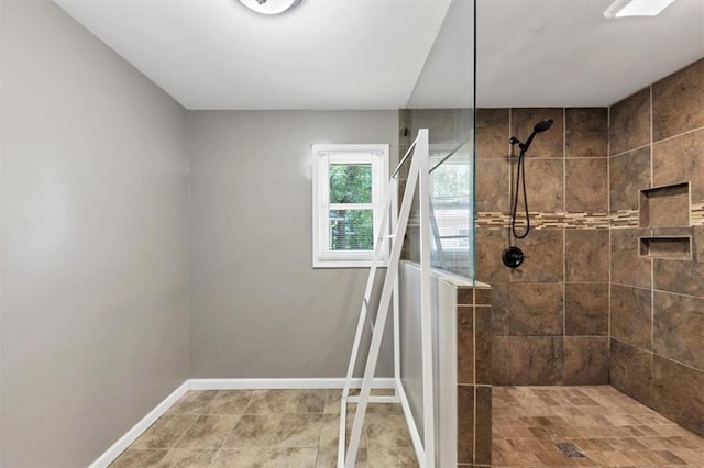 full bath featuring a walk in shower and baseboards