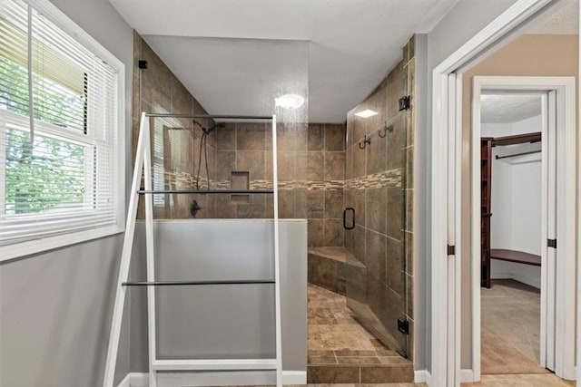 bathroom with a stall shower and baseboards