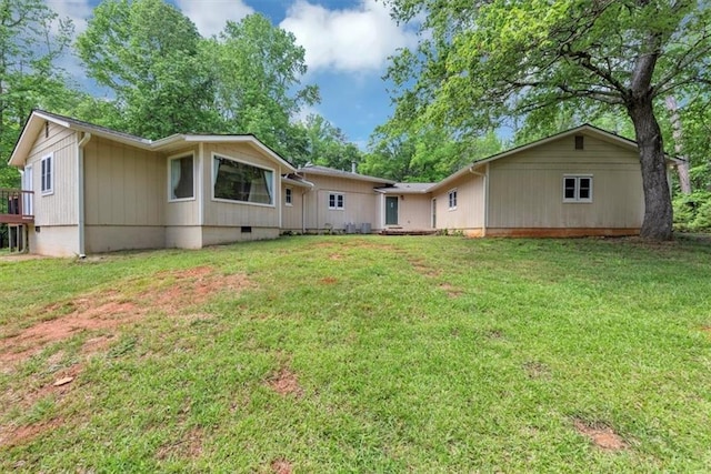 back of property featuring a yard