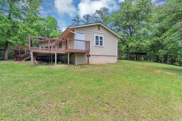 rear view of property featuring a wooden deck and a yard