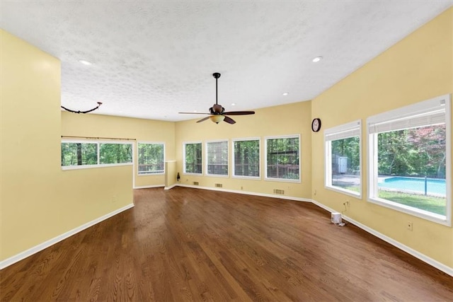 unfurnished living room with baseboards, ceiling fan, dark wood finished floors, and recessed lighting