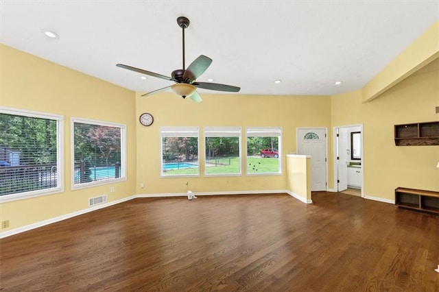 unfurnished living room featuring dark wood finished floors, a ceiling fan, baseboards, and recessed lighting