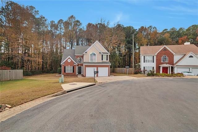 view of front of house with a garage and a front lawn