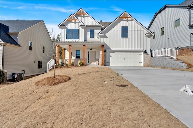 modern farmhouse style home with board and batten siding, a porch, concrete driveway, a garage, and a standing seam roof