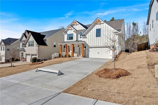 modern farmhouse featuring a porch, a residential view, concrete driveway, a garage, and board and batten siding