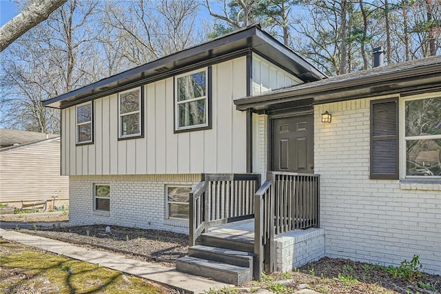 view of front facade with board and batten siding and brick siding