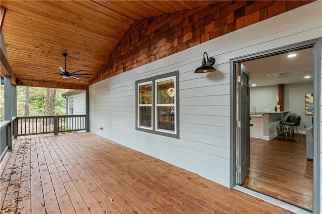 wooden deck featuring ceiling fan