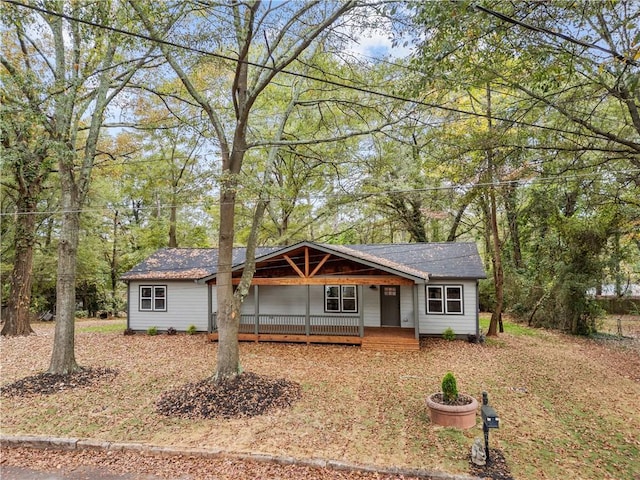 single story home featuring covered porch