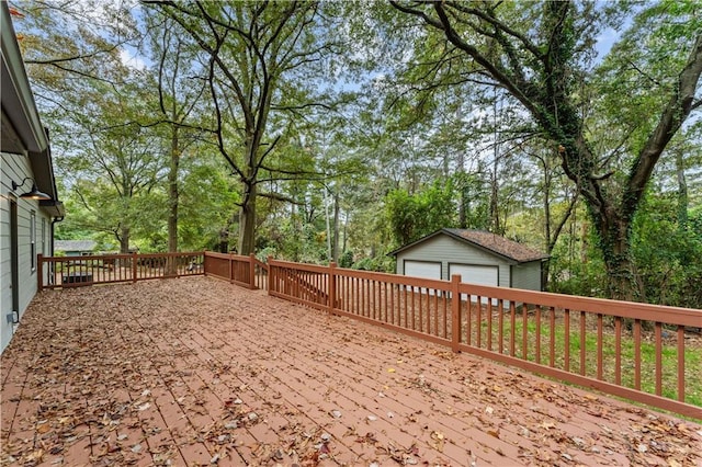 view of yard with a garage, an outbuilding, and a deck