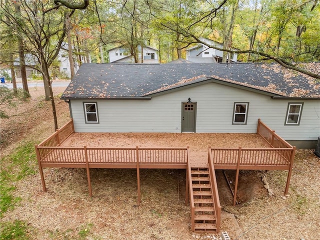 rear view of house featuring a wooden deck