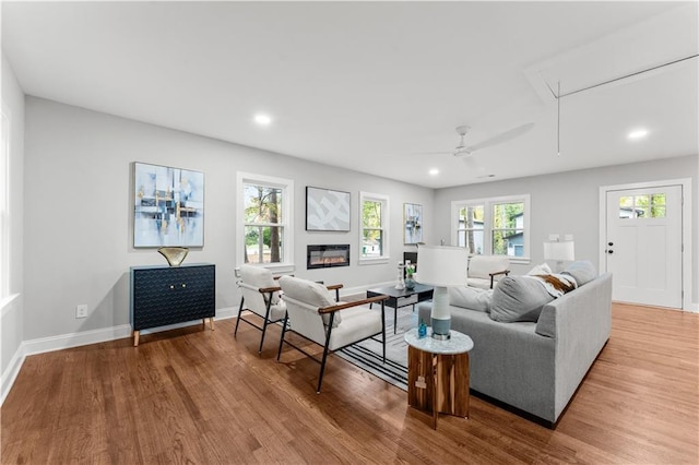 living room featuring ceiling fan and light wood-type flooring