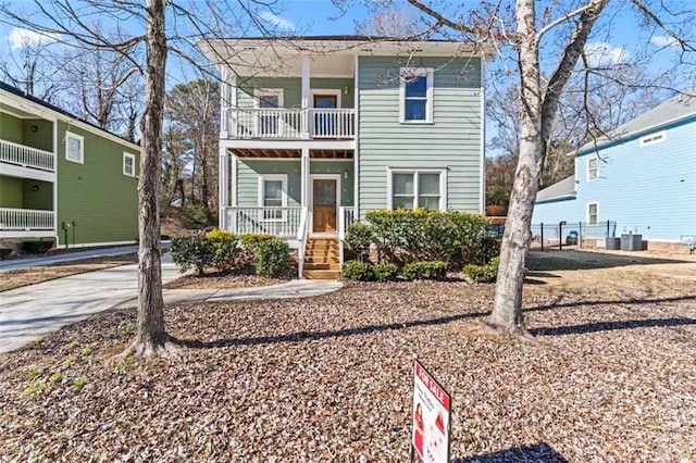 view of front of property with central AC and a balcony