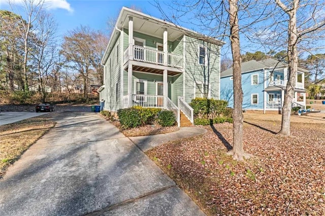 view of front of property with a balcony and covered porch