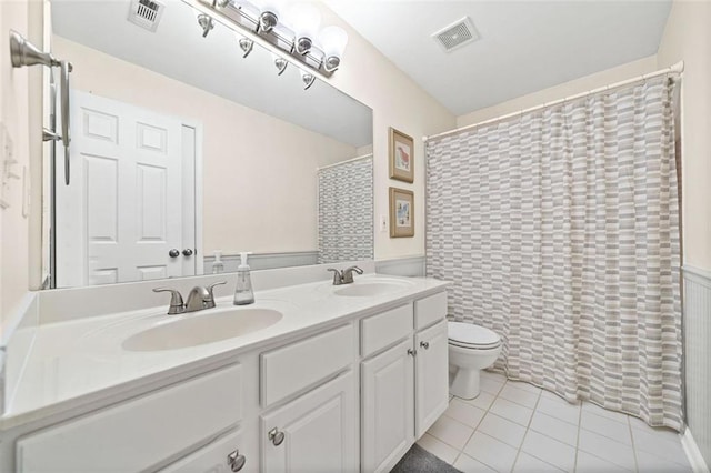 bathroom with a shower with curtain, vanity, toilet, and tile patterned flooring