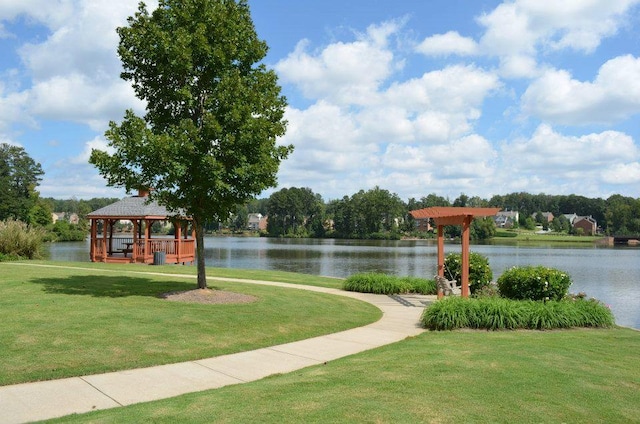 view of community featuring a gazebo, a water view, and a lawn