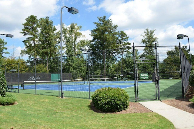 view of sport court featuring a lawn