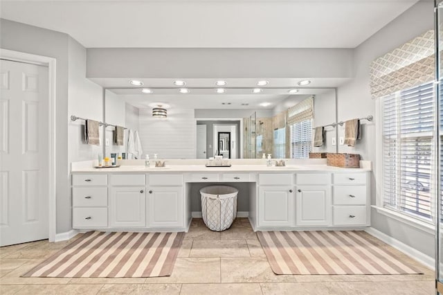 bathroom with vanity, a wealth of natural light, and walk in shower