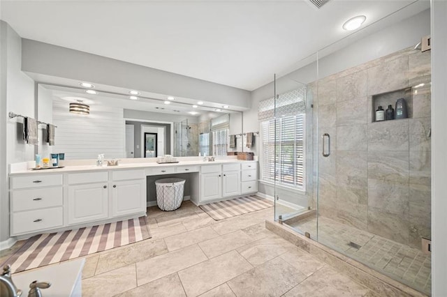 bathroom with vanity and a shower with shower door