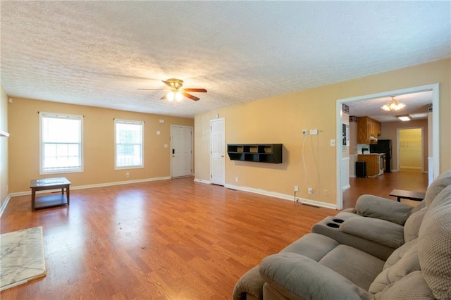 5425 Windswept Trce, Sugar Hill, GA 30518 - living room featuring ceiling fan, light wood-style floors, a textured ceiling, and baseboards