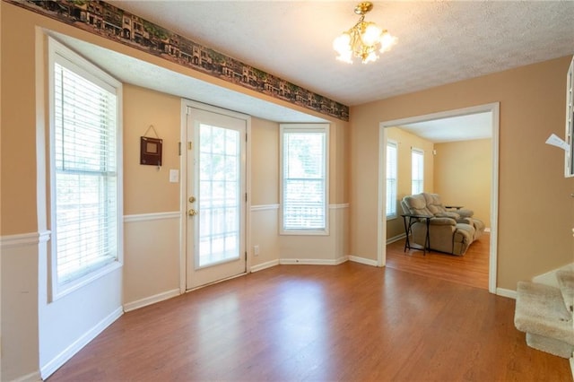 5425 Windswept Trce, Sugar Hill, GA 30518 - entryway with wood finished floors, a chandelier, and baseboards