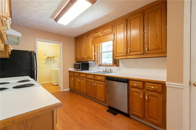 5425 Windswept Trce, Sugar Hill, GA 30518 - kitchen with stainless steel appliances, a sink, under cabinet range hood, brown cabinetry, and a textured ceiling