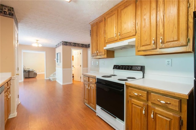 5425 Windswept Trce, Sugar Hill, GA 30518 - kitchen with electric stove, under cabinet range hood, light countertops, a textured ceiling, and light wood-style flooring