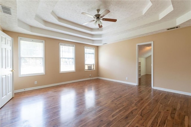 5425 Windswept Trce, Sugar Hill, GA 30518 - spare room with a raised ceiling, wood finished floors, a ceiling fan, a textured ceiling, and baseboards