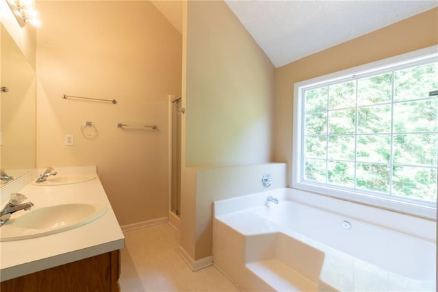 5425 Windswept Trce, Sugar Hill, GA 30518 - bathroom with lofted ceiling, a bath, double vanity, a stall shower, and baseboards