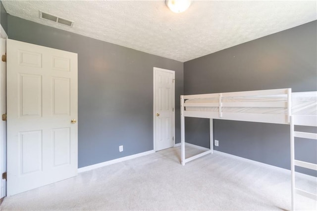 5425 Windswept Trce, Sugar Hill, GA 30518 - unfurnished bedroom with a textured ceiling, carpet, and baseboards
