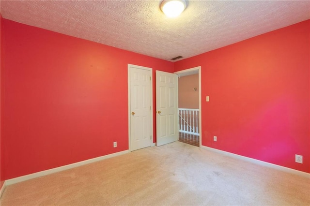 5425 Windswept Trce, Sugar Hill, GA 30518 - unfurnished bedroom featuring carpet flooring, baseboards, a textured ceiling, and a closet