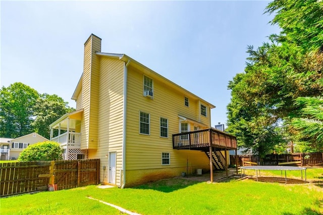 5425 Windswept Trce, Sugar Hill, GA 30518 - back of property featuring stairs, a trampoline, a chimney, and a wooden deck