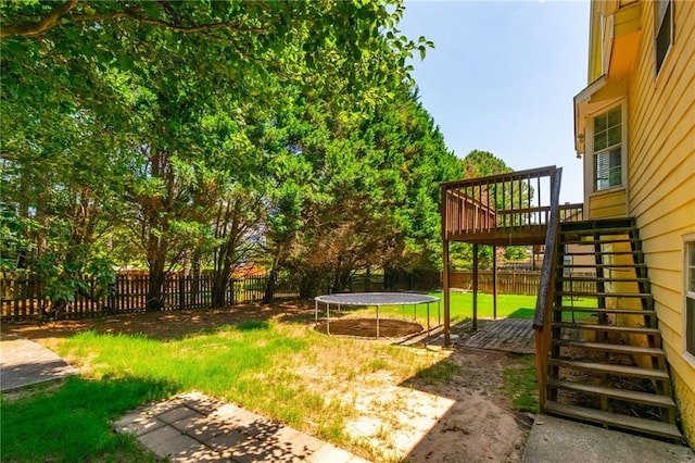 5425 Windswept Trce, Sugar Hill, GA 30518 - view of yard featuring a trampoline, stairs, and a wooden deck