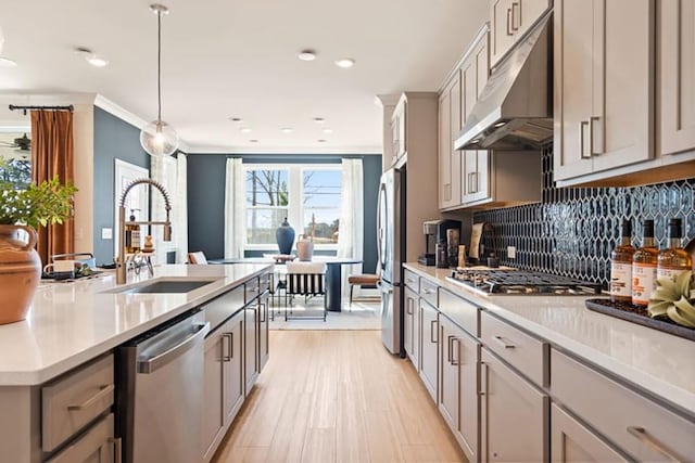 kitchen with sink, pendant lighting, appliances with stainless steel finishes, and gray cabinetry