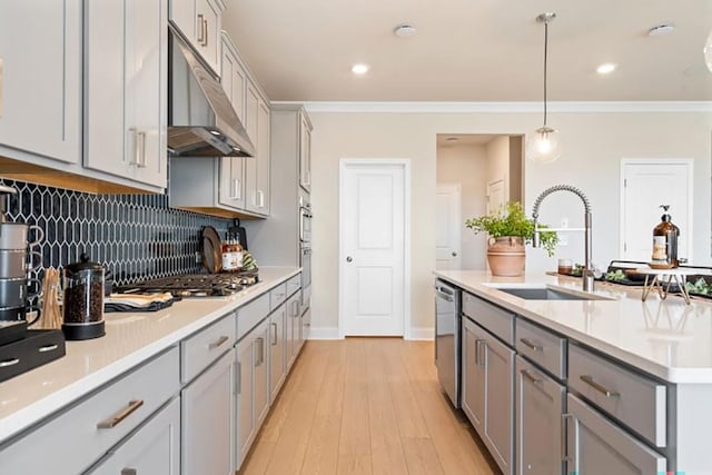 1446 Auburn Glen Rd, Dacula, GA 30019 - kitchen with gray cabinetry, a sink, under cabinet range hood, stainless steel appliances, and crown molding