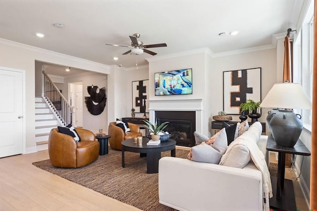 living room featuring ceiling fan, crown molding, and wood-type flooring