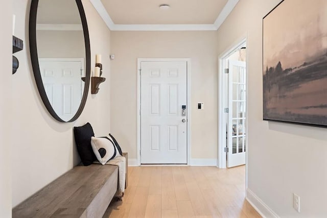 interior space with light hardwood / wood-style flooring and ornamental molding