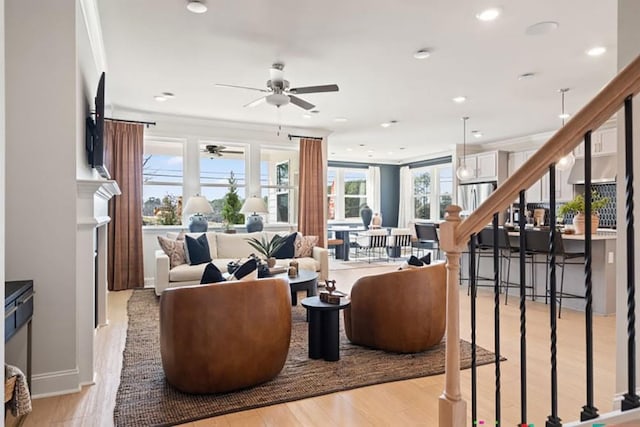 living room featuring crown molding and light hardwood / wood-style flooring