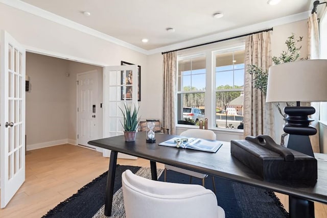 office featuring light wood-type flooring, french doors, and crown molding