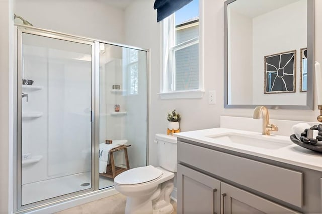 bathroom with vanity, toilet, tile patterned flooring, and a shower with door