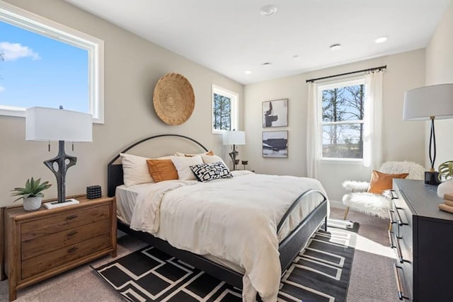 bedroom with carpet and multiple windows